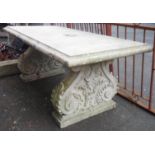 A 6' 2" concrete coated fibreglass framed garden table, set on classical standard scroll ends with