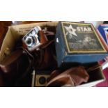 A box containing vintage cameras including 1930's Ensign Purma Special, AGFA Billy, Pentax PC35AF,