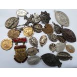 A collection of various old Christian medallions and badges including the Catholic Association