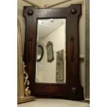 A 1920's oak framed wall mirror with applied decoration and bevelled oblong plate