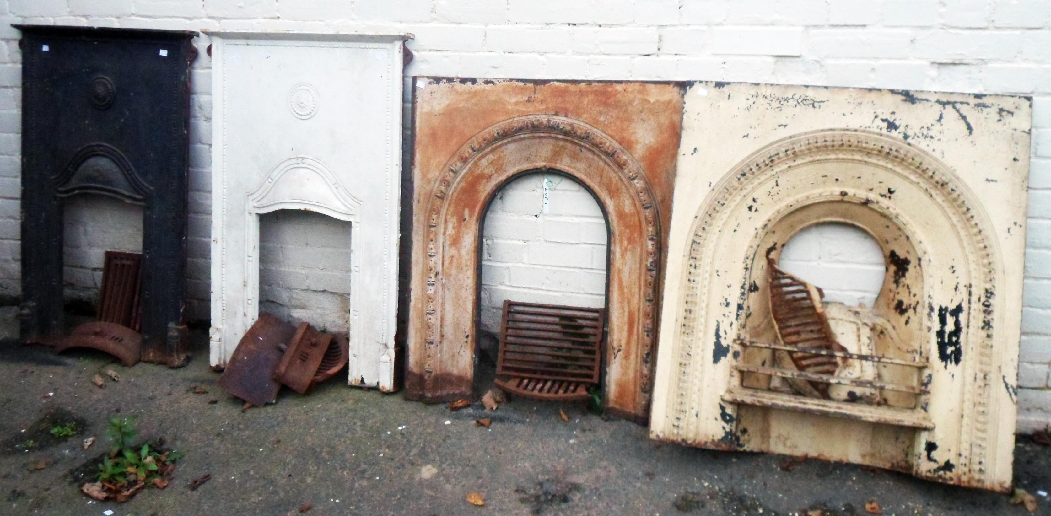 Two pairs of Victorian cast iron fire surrounds, in two styles with grates