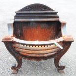 A cast iron fire basket in the Georgian style with scroll front supports