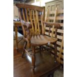 An antique lath back elbow chair with solid elm seat, set on turned supports - old repairs