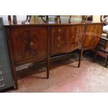 A 5' 7" reproduction mahogany serpentine front sideboard with three central graduated drawers and