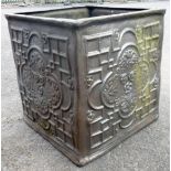 A 28" square fibreglass planter in the form of an antique lead water tank with raised decoration