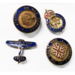 Four First World War and later enamelled lapel and pin badges comprising On War Service 1914