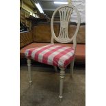 A pair of painted wood framed dining chairs with upholstered seats