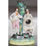 A Staffordshire spill vase in the form of a courting couple by a tree