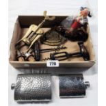 A box containing a collection of corkscrews, wine pourers and hip flasks, etc.