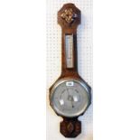 A mid 20th Century carved oak cased aneroid banjo barometer/thermometer