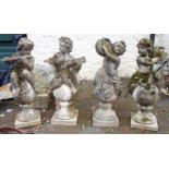 A set of four 3' 4" concrete garden statues, each in the form putto sitting on top of a ball