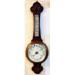 An early 20th Century carved oak framed aneroid banjo barometer/thermometer with printed scale and