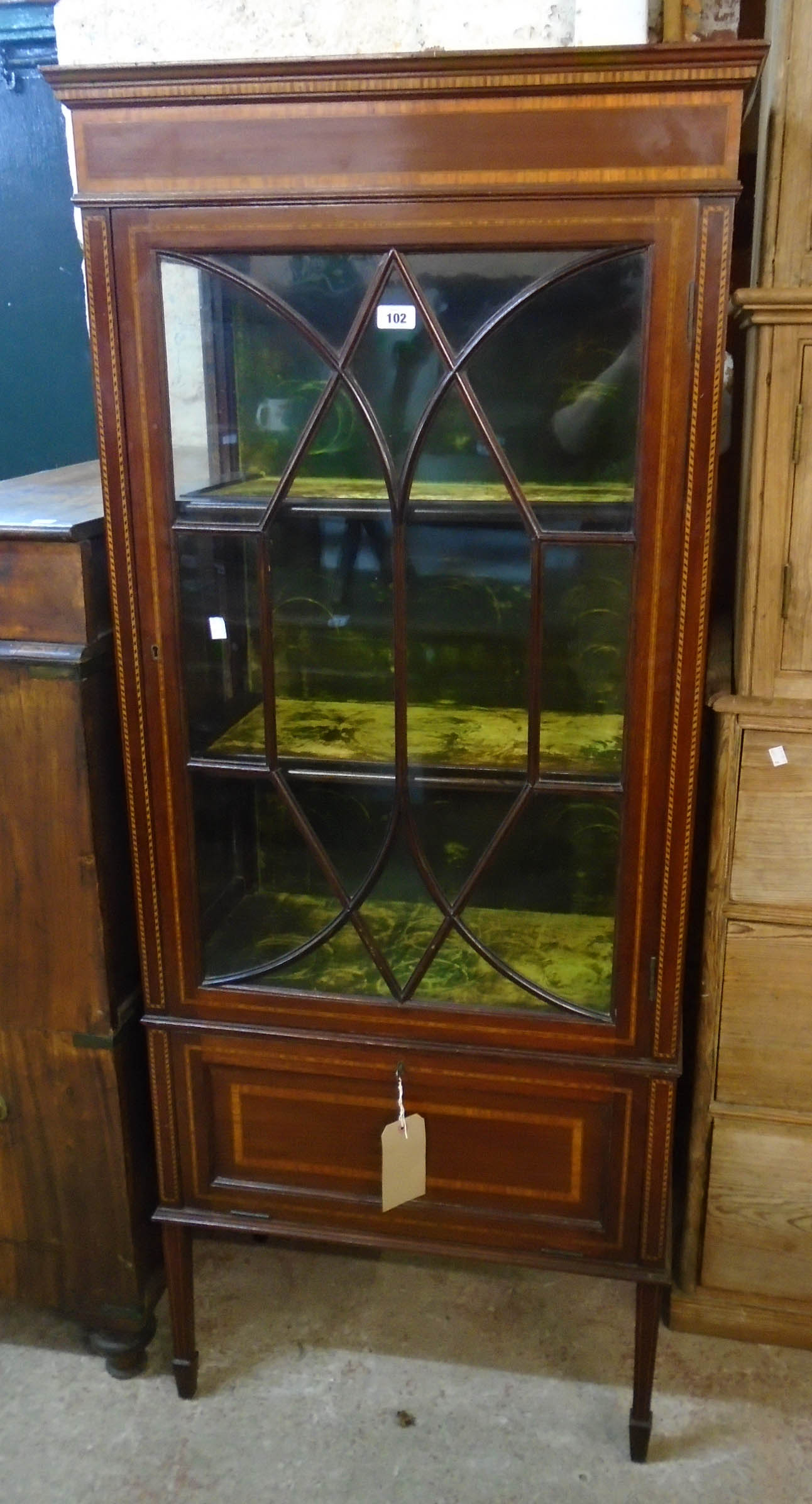 A 27" Edwardian inlaid mahogany display cabinet with three green velvet lined shelves enclosed by an