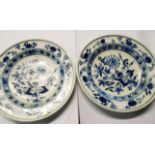 A pair of 9 1/2" diameter continental blue and white plates with floral decoration in onion borders,