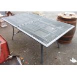 An extending garden table with wire mesh top and stowed folding leaf, set on swept supports - 7' 11"