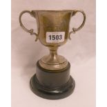 A silver two handled trophy cup with text "Slapton Cup 1911", set on socle base - a/f