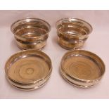 A pair of silver deep wine coasters with turned wood bases - sold with two others