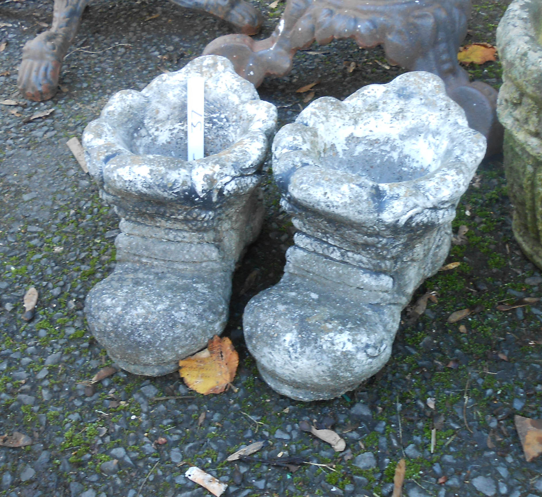 A pair of concrete boot pattern planters