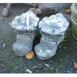 A pair of concrete boot pattern planters