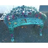 A colour painted cast aluminium curved garden bench with pierced grapevine decoration