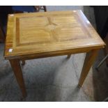 A 25" "Malabar" side table with moulded edge set on square tapered legs