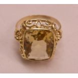 A yellow metal dress ring, set with large citrine