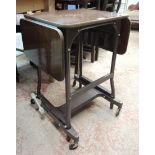 A vintage formica and painted metal office copier table with flanking drop-leaves and trolley base