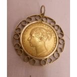 An 1876 Queen Victoria gold sovereign loose mounted in a marked 9ct. pierced yellow metal pendant