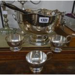 A silver plated copper punch bowl with six cups and ladle with turned wood handle