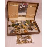 A brown leatherette jewellery box containing assorted costume jewellery including ear-rings, dress