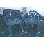 A pair of painted cast aluminium garden tub elbow chairs with pierced grapevine decoration