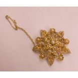 A yellow metal and seed pearl set floral starburst pattern brooch