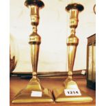 A pair of brass ejector candlesticks - sold with three old soldering irons