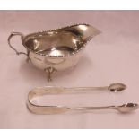 A silver sauce boat with cast rim and hoof pattern feet - sold with a pair of silver fiddle