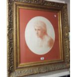 An antique ornate gilt gesso framed and oval slipped red chalk head and shoulders portrait of a