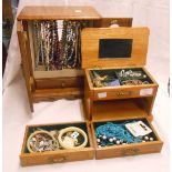 A two door jewellery cabinet and chest style similar containing assorted costume jewellery