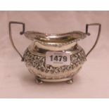 A silver sugar bowl with ornate embossed C-scroll and cartouche decoration - Chester 1903