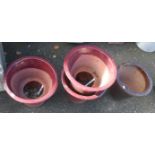 Three matching 16" diameter maroon glazed terracotta planters - sold with one other