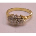 An 18ct. gold ring with diamond cluster in marquise shaped panel