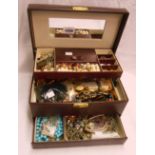 A burgundy concertina jewellery box containing a quantity of assorted costume jewellery, etc.