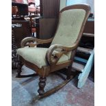 A Victorian mahogany framed rocking chair with button back upholstery and open scroll armrests - a/