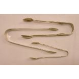 A pair of Edinburgh silver ornate sugar tongs marked "Edward" - 1879 - sold with two other pairs