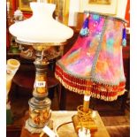 An oil lamp style table with glass chimney and shade - sold with further table lamp with elaborate