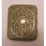 A decorative white metal filigree cigarette case with applied cartouche "Olive"