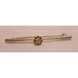 A boxed unmarked high carat yellow and white metal diamond solitaire bar brooch