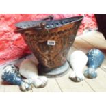 A coal bucket containing four cast iron bath feet