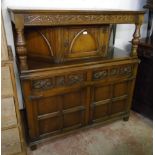 A 4' 1" 20th Century polished oak court cupboard with Gothic style decoration, canted top section