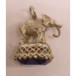 A white metal elephant pattern fob seal, set with amethyst glass faceted panel