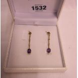 A pair of yellow metal, amethyst and seed pear drop ear-rings