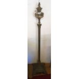 A brass oil lamp standard with Corinthian column, stepped plinth base and stylised lion paw feet -